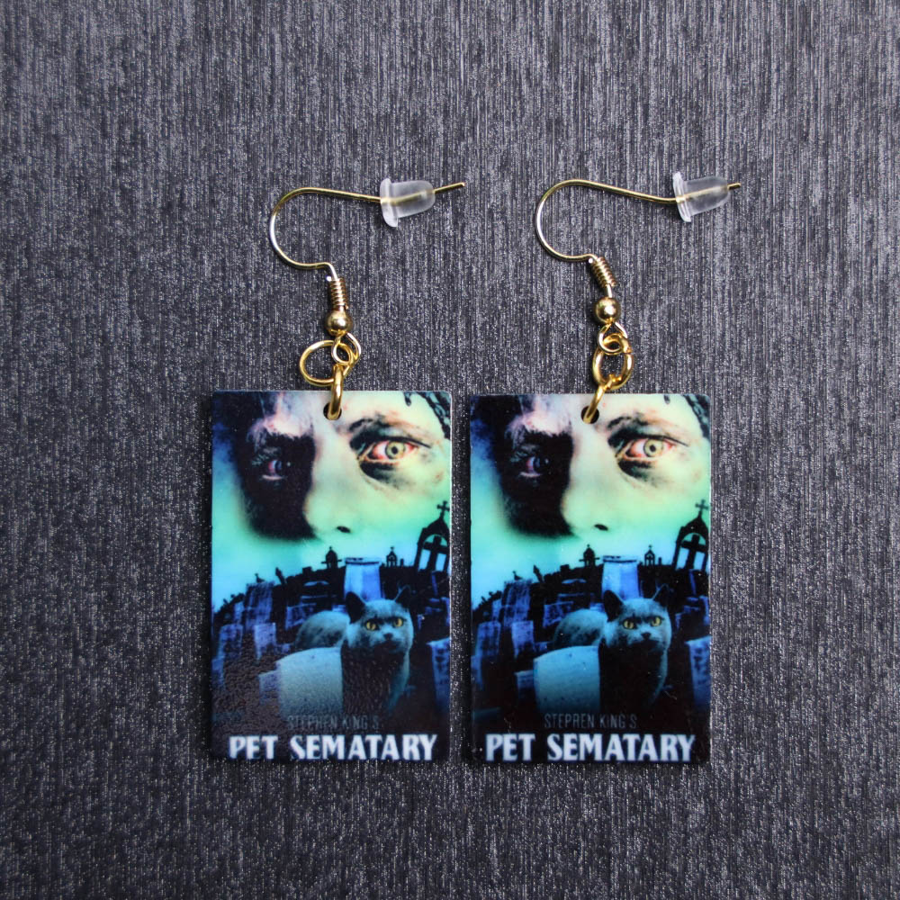 Pet Sematary Poster Earrings. These earrings are made with acrylic and hand heat pressed. Comes with 18k plated gold hooks that is nickel free.