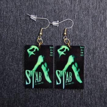 Stab Poster Earrings. These earrings are made with acrylic and hand heat pressed. Comes with 18k plated gold hooks that is nickel free.
