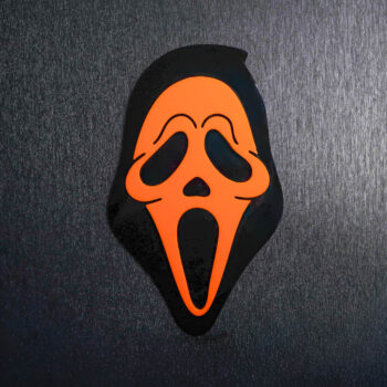 Ghostface Orange Sign. This sign is made with black acrylic base and a orange acrylic topper. Comes with attachable keyhole.