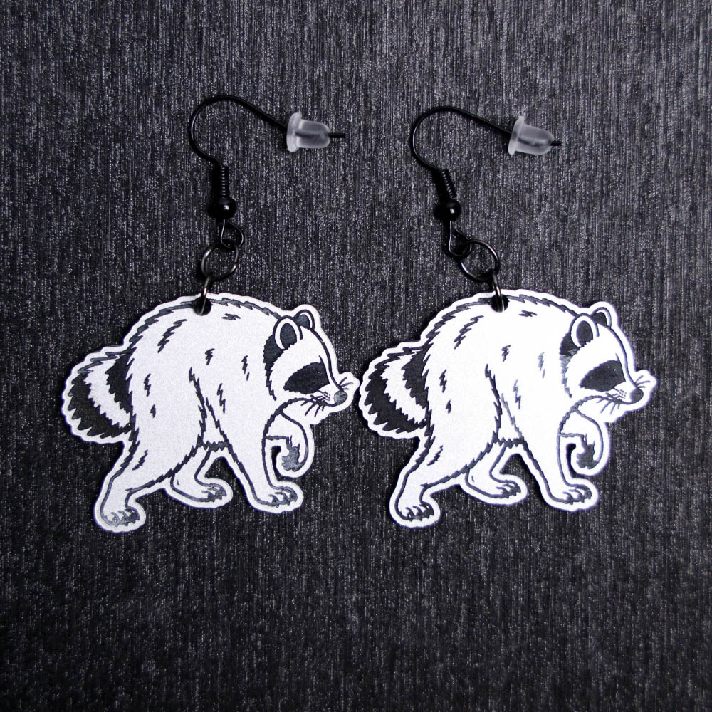 Jimothy Earrings. These earrings are made with silver to black acrylic (the picture looks white but is a silver). Comes with black hooks that is nickel free.