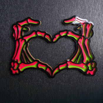Skeleton Hands Neon Sign. This sign is made with neon green acrylic base, hot pink acrylic center, and a black acrylic topper. Comes with attachable keyhole.