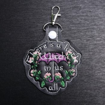 A Little Witch Practical Magic Bag Tag. This bag tag is made with faux vinyl and embroidered. Comes with lobster clasp topper that easily hooks to a bag, zippers,