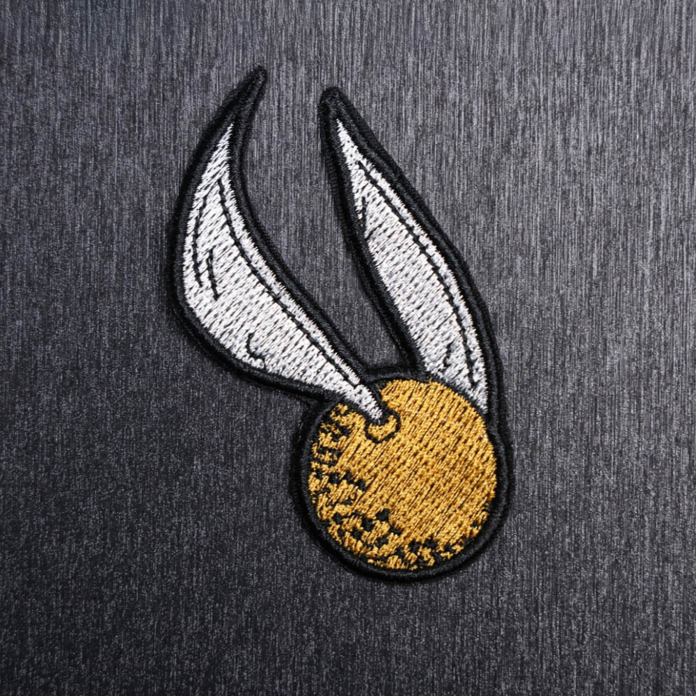Golden Snitch Patch Sew On in white, yellow gold, and black. Beautifully embroidered design which is sew on design. Just sew or glue with E6000 glue onto your favorite bag, vest, or clothing.