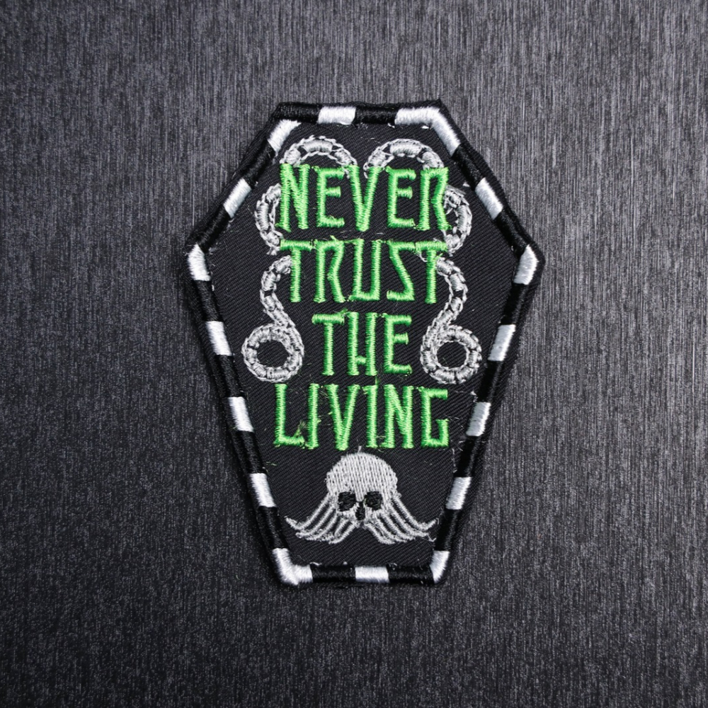 Never Trust The Living Patch Sew On in white, green, and black. Beautifully embroidered design which is sew on design. Just sew or glue with E6000 glue onto your favorite bag, vest, or clothing.
