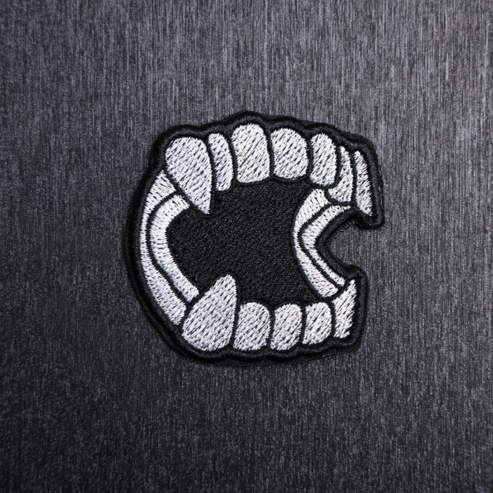 Vampire Teeth Patch Sew On in white and black. Beautifully embroidered design which is sew on design. Just sew or glue with E6000 glue onto your favorite bag, vest, or clothing.